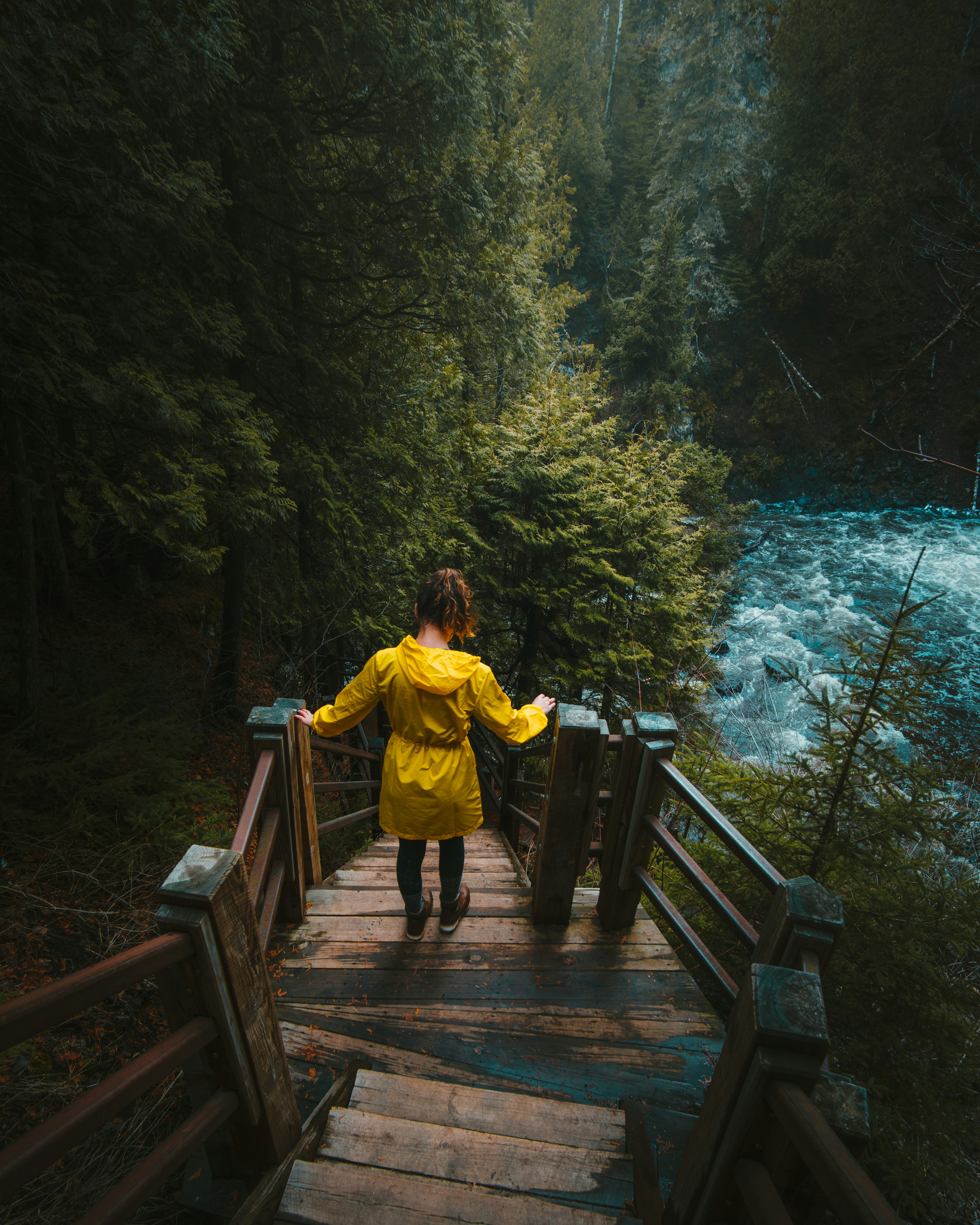 woman in stair near body of water during daytime